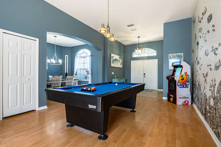 You can see the pool table through the glass doors — play a round inside, then step right out to cool off