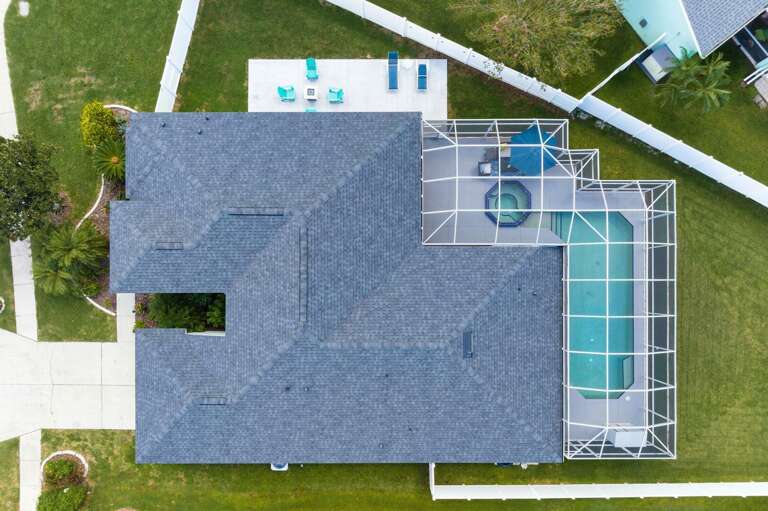 Your own slice of Bradenton from above — the pool, the lawn, and the neighborhood spread out below