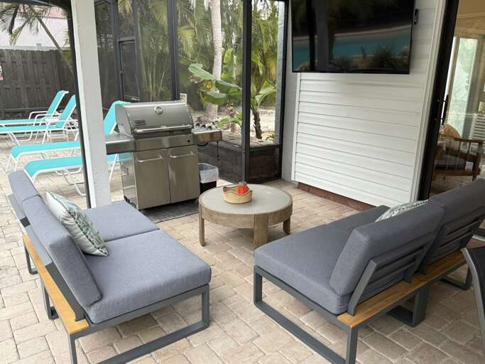Fire up the grill under the covered lanai. The game's on behind you, and nobody's rushing you inside tonight.