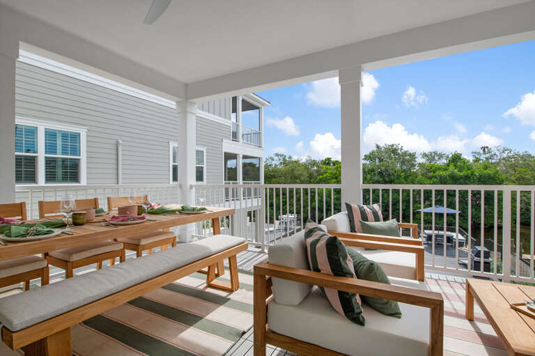 Morning coffee on the covered balcony, tree canopy at eye level, nobody talking yet. The best hour of the day starts right here before anyone else is up.