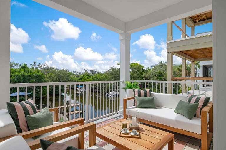 Settle into the cushioned sofas and watch the canal below — dolphins and manatees have been spotted from this exact railing on more than one stay.
