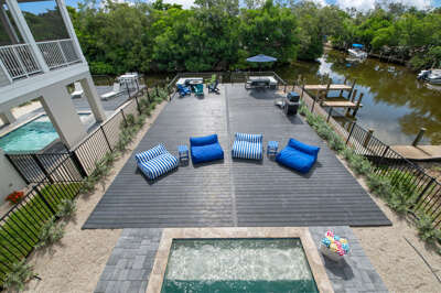 Step back and take it all in — your private deck, heated pool, and boat dock all in one aerial view. This is the whole package, and it's yours for the week.