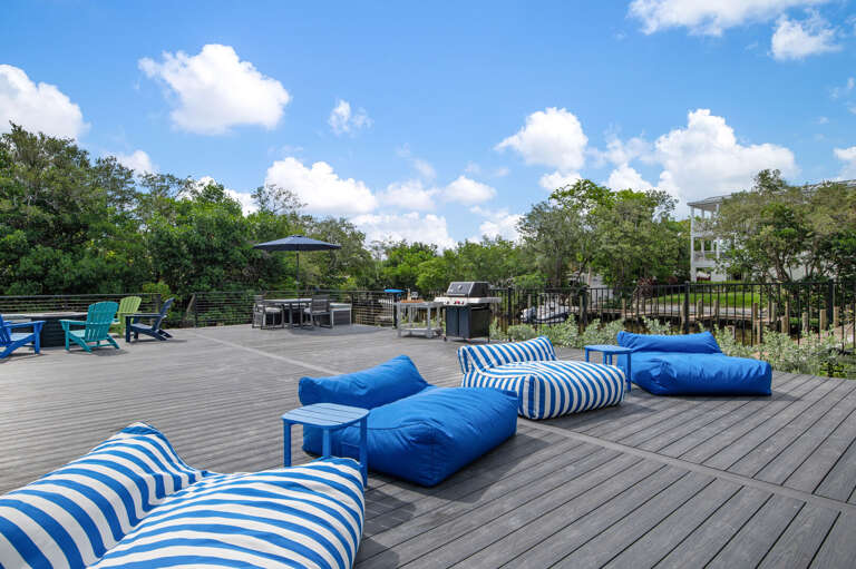 Toss the bean bags, fire up the grill at the other end — the deck is big enough that everyone finds their spot without tripping over each other.