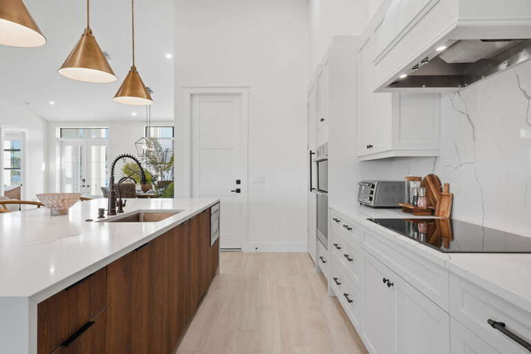 Cook with a full professional setup — stainless appliances, clean lines, and enough counter space to actually prep without the elbow wars.