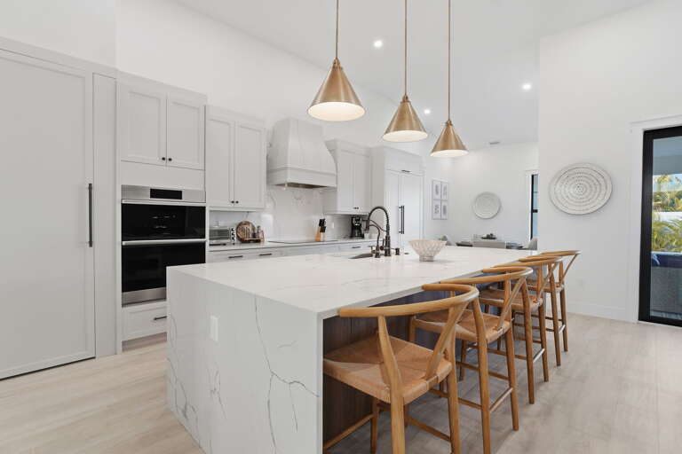 Cook a real meal here — premium appliances, custom cabinetry, and a large island that becomes the center of every gathering.