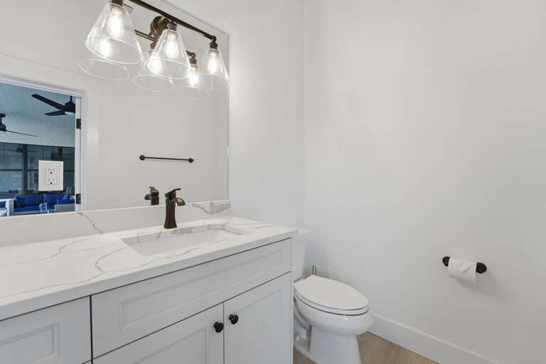 Find the half bath off the pool area — it handles pool time traffic so nobody has to go inside.