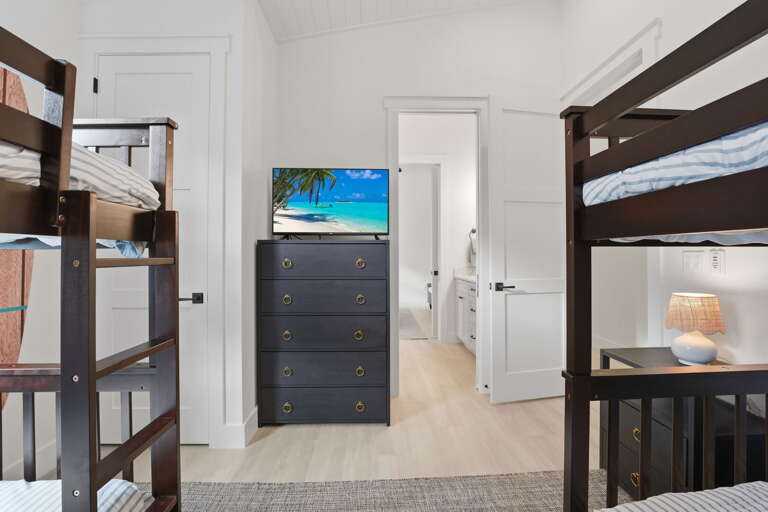 Find a room that actually works for whoever drew the short straw — coastal touches and a flexible setup that's better than expected.