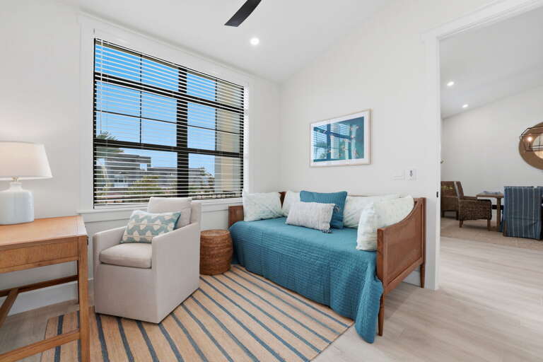 Head to Bedroom 5 — twin beds, natural light, and a dedicated workspace desk for the person on the trip who still has to answer emails.
