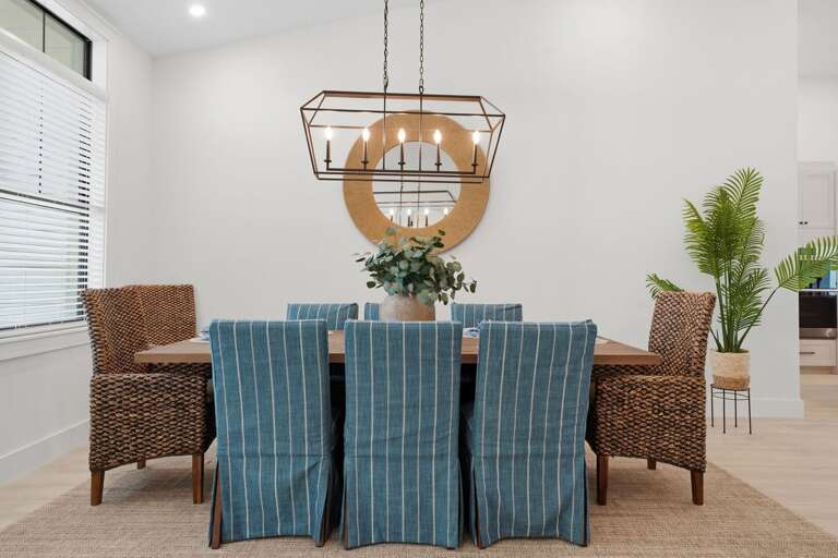 Pour the wine, plate the food, and gather everyone in — natural light, a proper chandelier overhead, and no one eating on a TV tray.