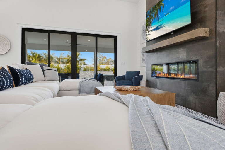 Pull the seating into whatever arrangement works for the night — board games, a movie, a long dinner conversation. The room is ready for all of it.