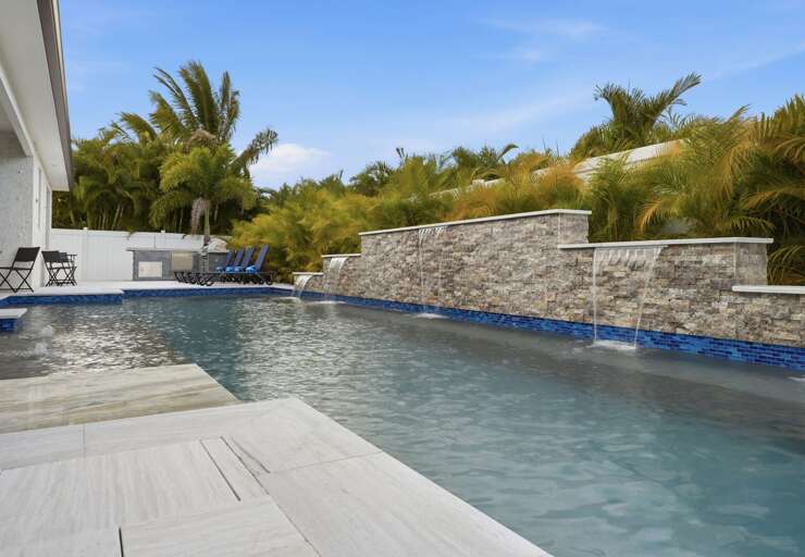 Soak in the full-width pool as the deck spreads around you — built wide enough for the whole group at once.