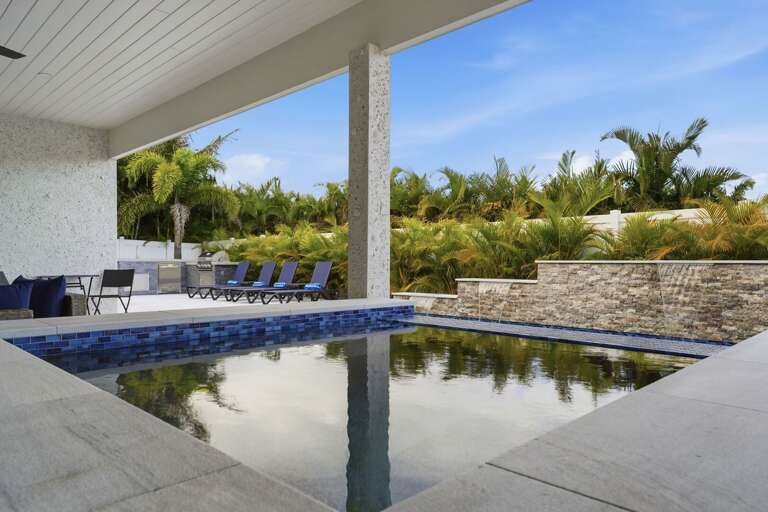 Step out and drop right in — the heated pool with waterfall feature, sun shelf bubblers, and spa waits for you every single day of the stay.