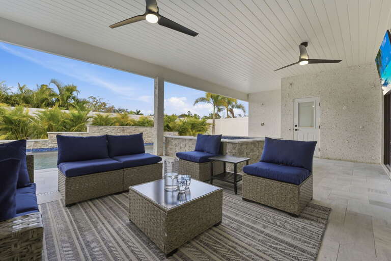 Step onto the back patio and feel inside melt into out — deck underfoot, yard behind you, the Florida lifestyle exactly right.