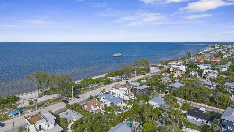 From above, you can see exactly what you're working with — pool, yard, patio, all steps from the beach.