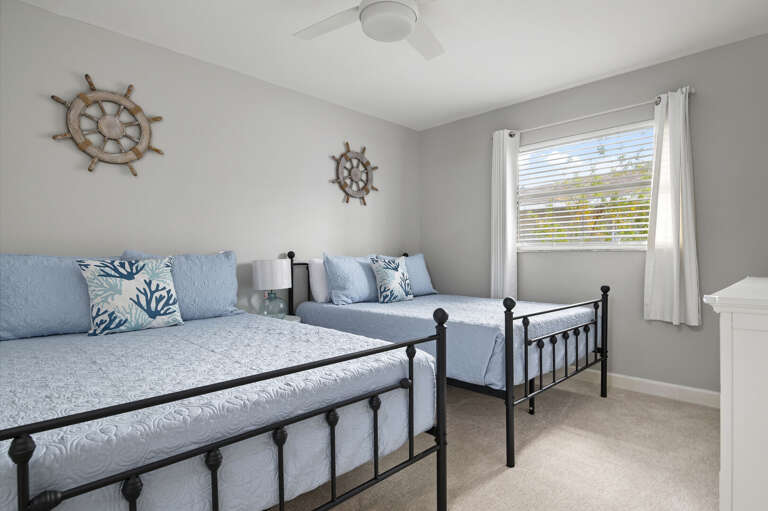Claim the iron beds before your sister does — the twin room is a kids' favorite with coastal blue bedding and its own TV.