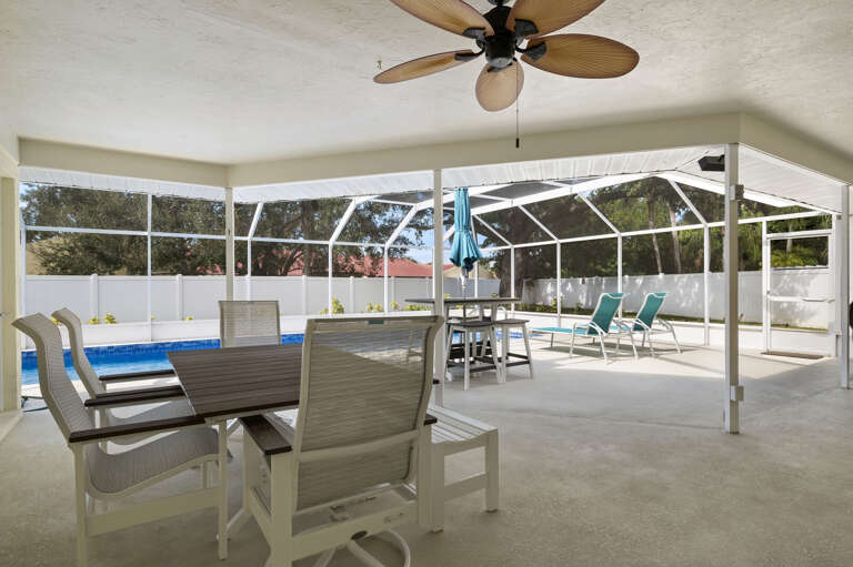 Dine al fresco without the mosquitoes — the covered lanai keeps you cool while the pool sparkles just beyond your meal.