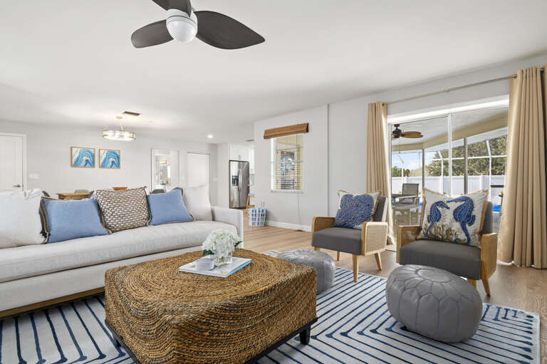 Kick back on the sofa with the pool just steps away — this open living space keeps the Florida sunshine in frame all day.