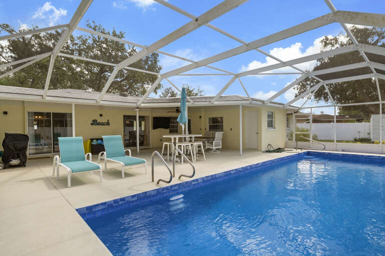 Pull up a lounger and let the afternoon disappear — the screened enclosure means no bugs, just sunshine and cool water.