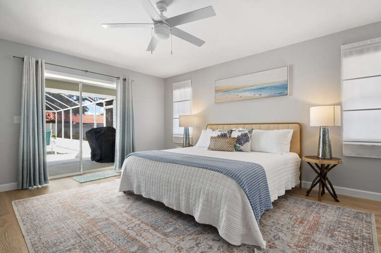 Roll out of bed and into the pool — the primary bedroom has its own sliding door straight to the screened pool deck.