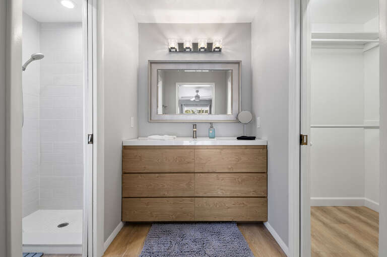 Start every morning in this spa-style ensuite — wood floating vanity, walk-in shower, and a mirror the size it should be.
