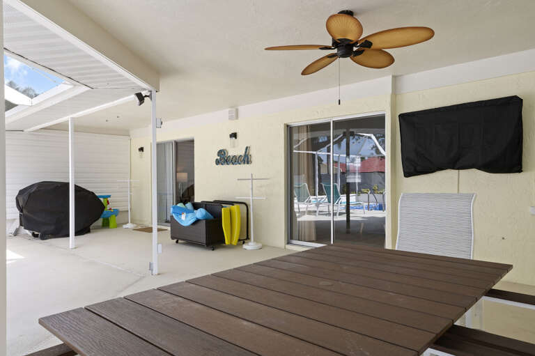 Watch the game from the lanai with the pool just behind you — the outdoor TV means you never have to choose between the two.