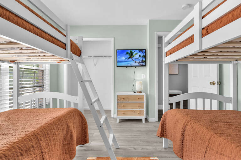 Let the kids claim their own room — the bunk room has its own TV and dresser so they're not camping out in anyone else's space.