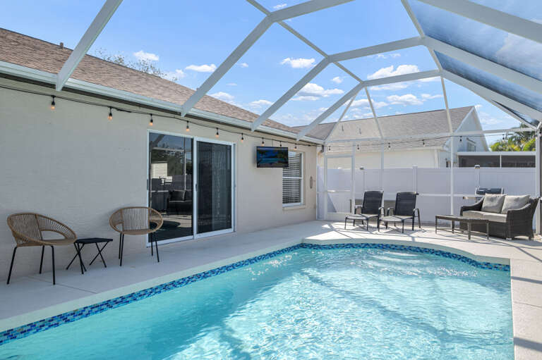 Your screened pool stretches the full length of the house — plenty of room to float, lounge, and never feel crowded.