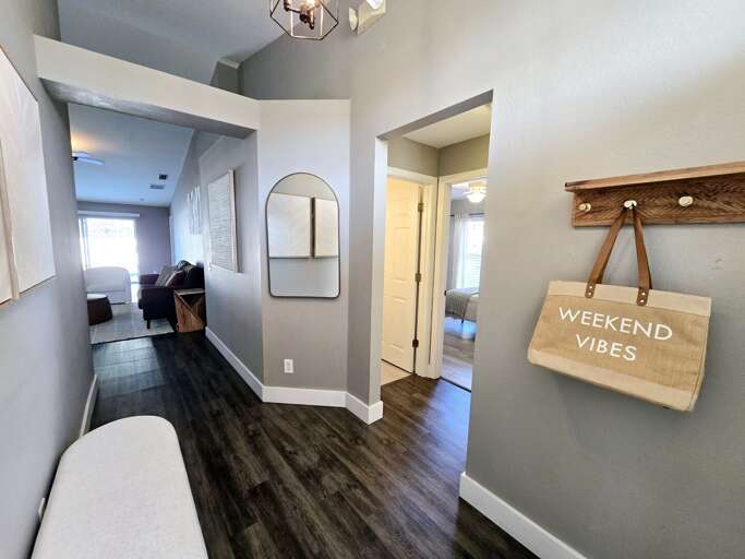 Set the tone the second you walk in — the arched hallway mirror and 'Weekend Vibes' hook tell you exactly what kind of trip this is going to be.