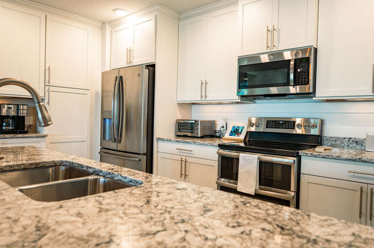 Every appliance you need is full-size and ready — double oven, over-range microwave, and a refrigerator that handles a full grocery run.