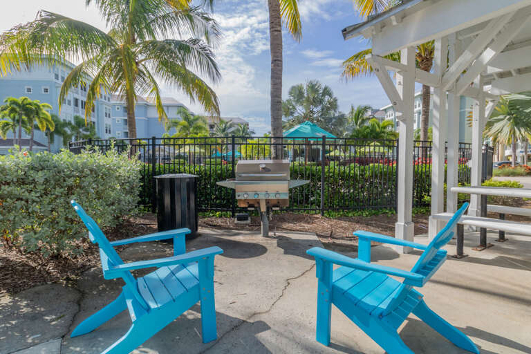 Fire up the community grill, pour something cold, and let dinner happen at its own pace — the palm trees and pergola make everything taste better.