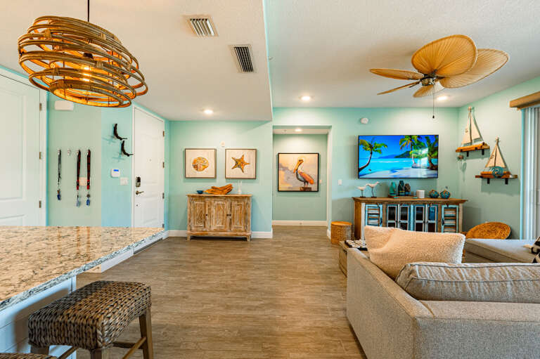 Grab a stool at the island and you are still part of the conversation in the living room — the open plan earns its keep.