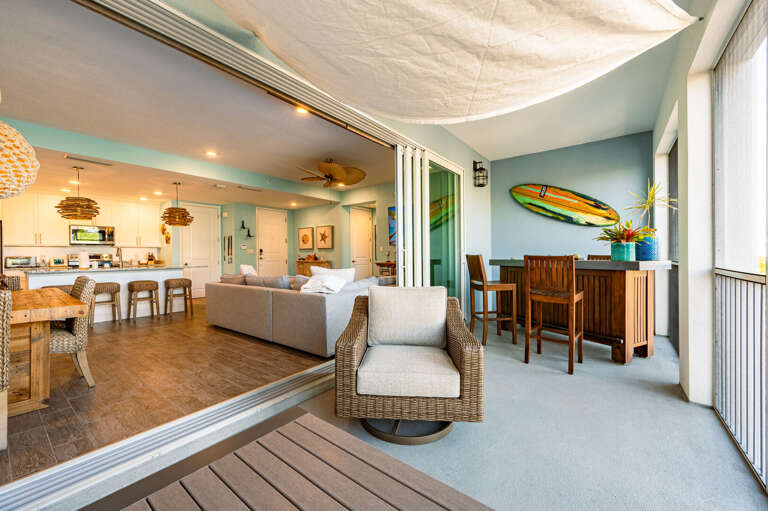 Your private outdoor reset button — a lounge chair, some shade, and surfboard art that reminds you exactly where you are.