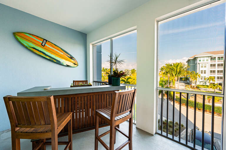 Pull up to the balcony bar table, watch the palm trees sway, and let happy hour stretch past sunset.