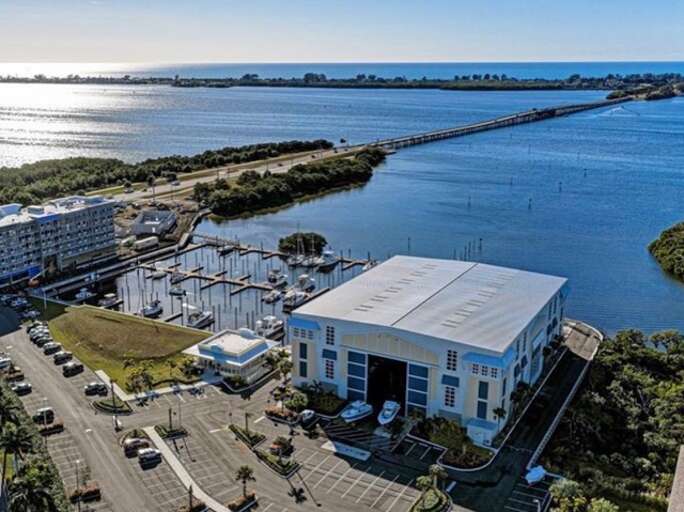 Step outside and this is the world you are in — boats in the marina, bay water glittering, and Anna Maria Island just one mile up the road.