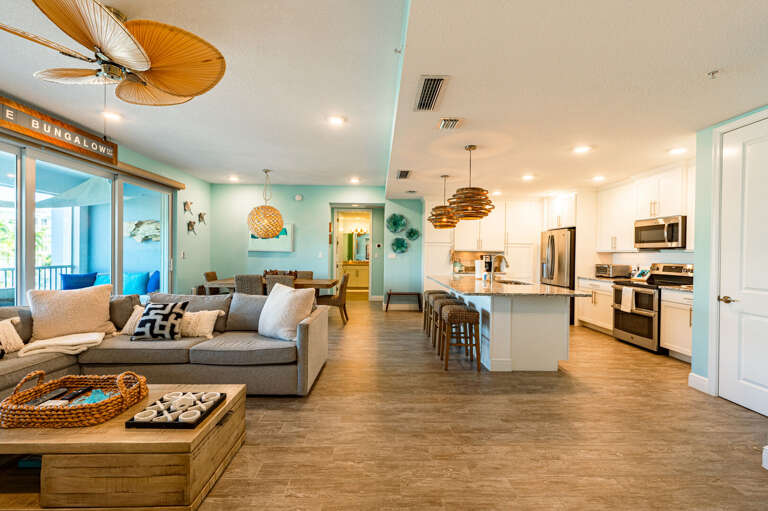 Turn around from the kitchen island and the whole living space opens up — this is what cooking on vacation should feel like.