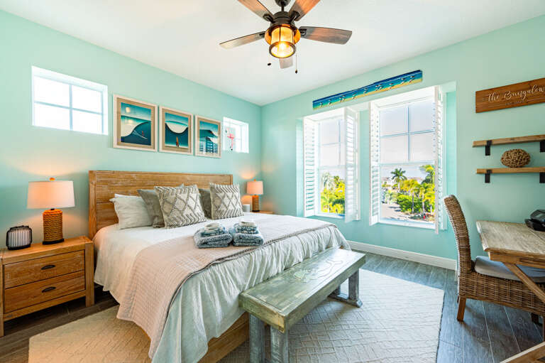 Wake up in the king bed, open the plantation shutters, and let the Florida light in — the coastal art triptych makes mornings worth lingering over.