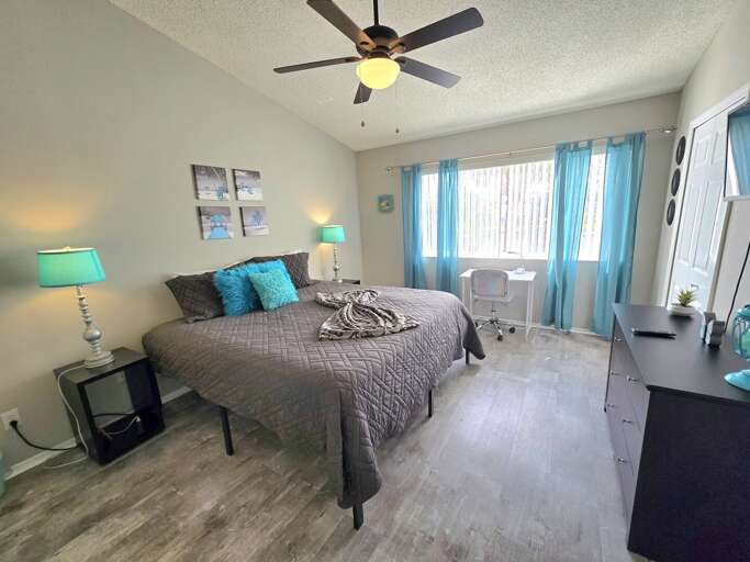 Drift off in the second bedroom wrapped in a teal-and-gray palette that's calm and hotel-cool.