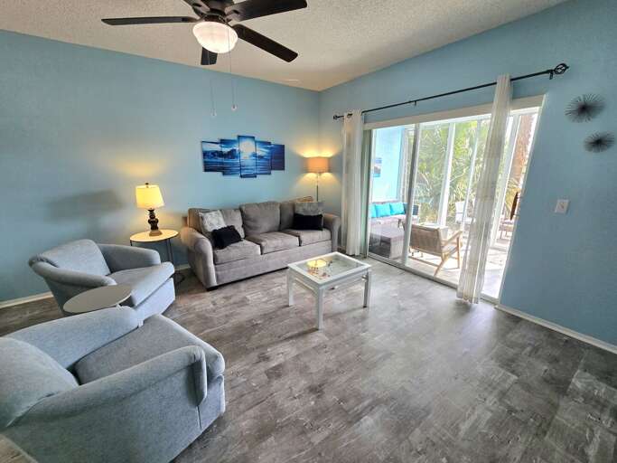 Lounge on the sofa with the sliding patio door open and let the outdoor breeze come inside.