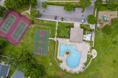 Step outside the gate and you've got it all — pool, basketball, tennis, and pickleball waiting.