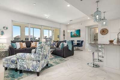 Brand new, open, spacious and comfortable living area offering plenty of seating and a 65" smart TV.  A wall of sliding doors open the space to the private lanai.