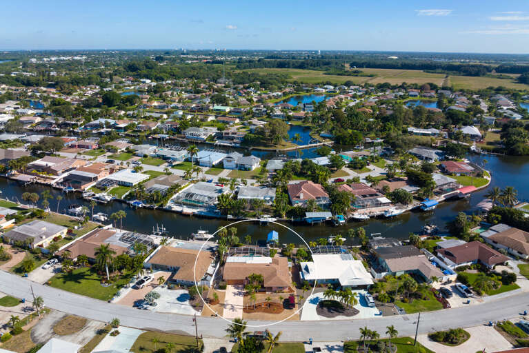 Find your exact property from above — circled here in the aerial so you can see your screened pool, dock, and canal access at a glance.
