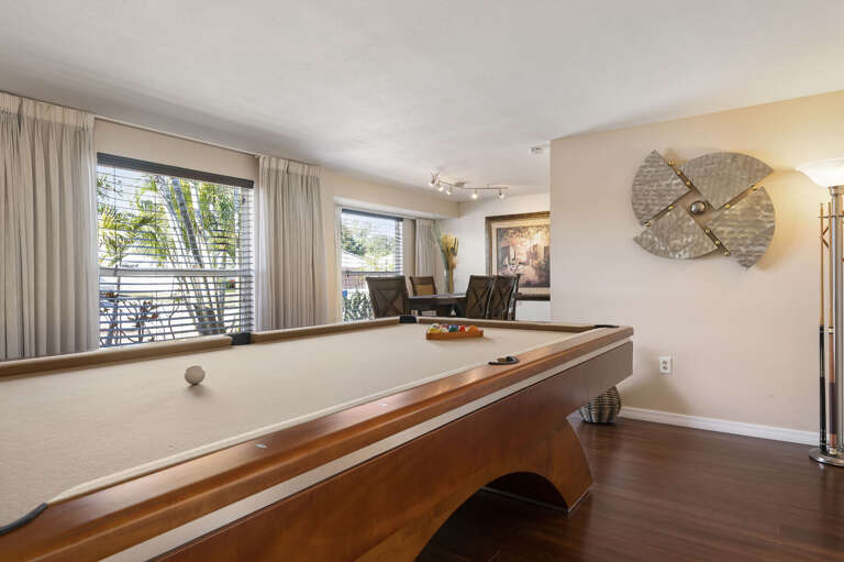 Head straight from the billiards table through to the dining room beyond — the open sight line makes it easy to entertain across both spaces.