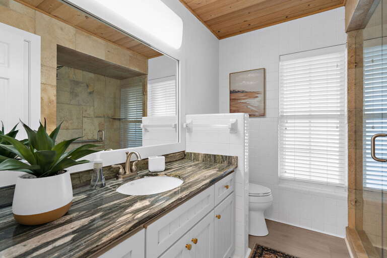 Use the second full bath any time you need it — tub-shower combo, dark granite vanity, and a big mirror so the whole crew can get ready without a traffic jam in the hall.