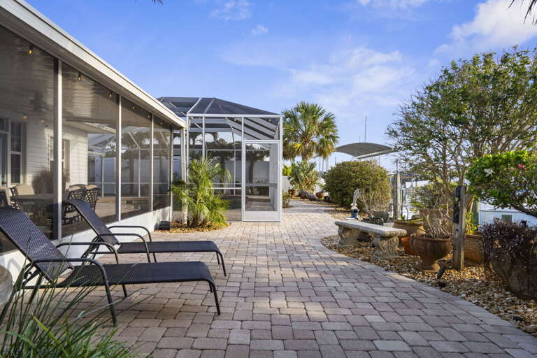 Spread out across the wide paver backyard between the pool and the dock — plenty of room for