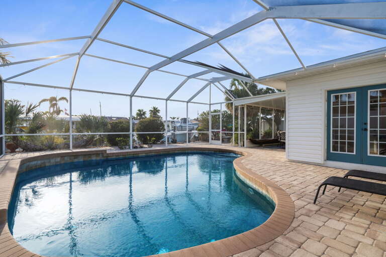 Step from the living room straight into the pool enclosure — it is literally three steps and you are in the water. No shoes needed, no detour required.