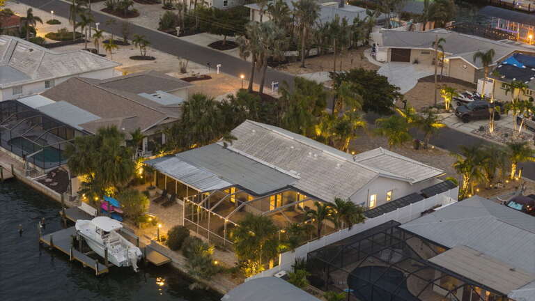 Step off the plane and picture this — your home base for the week, with a screened pool and private dock out back. This is where your Florida vacation actually begins.