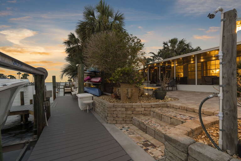 Walk to the end of your private dock at golden hour and let the canal do the rest — cast a line, load the kayaks, or sit with a drink while the water turns orange below you.