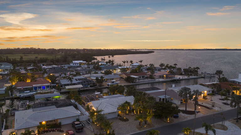 Watch this aerial sunset shot and understand why guests give the location 4.8 stars every time — the canal feeds directly to open bay water that glows gold at exactly this hour.