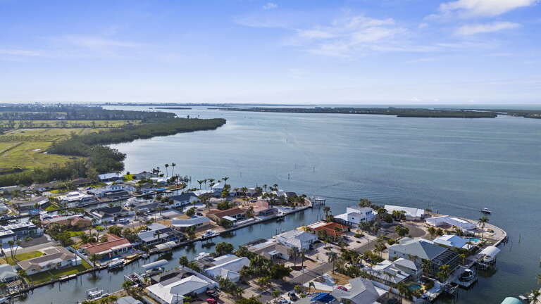 Zoom out to the full waterfront picture — your home sits on a peninsula threaded with calm canal inlets that open out to the bay just a short paddle from your dock.