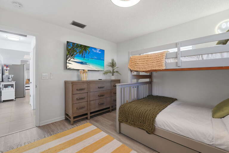 Adventure awaits after lights out! This bright bunk room keeps the little ones entertained with a flatscreen and playful island decor.